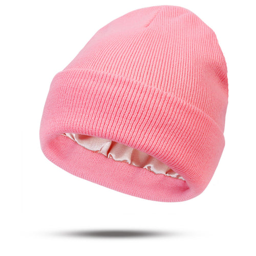 Pink beanie hat on a white background